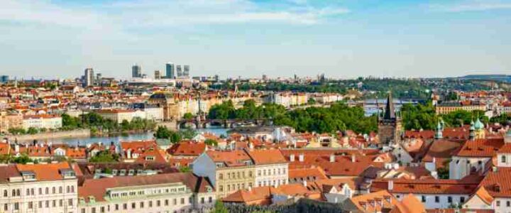 Explore the enchanting cityscape of Prague with its iconic red roofs and urban charm., tags: auf - pexel